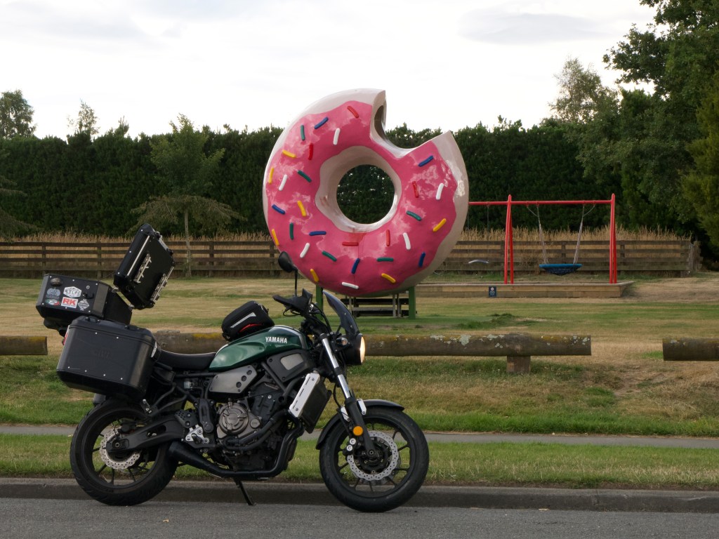 Photo of a 2017 Yamaha XSR700 in Forest Green. It has full touring luggage.